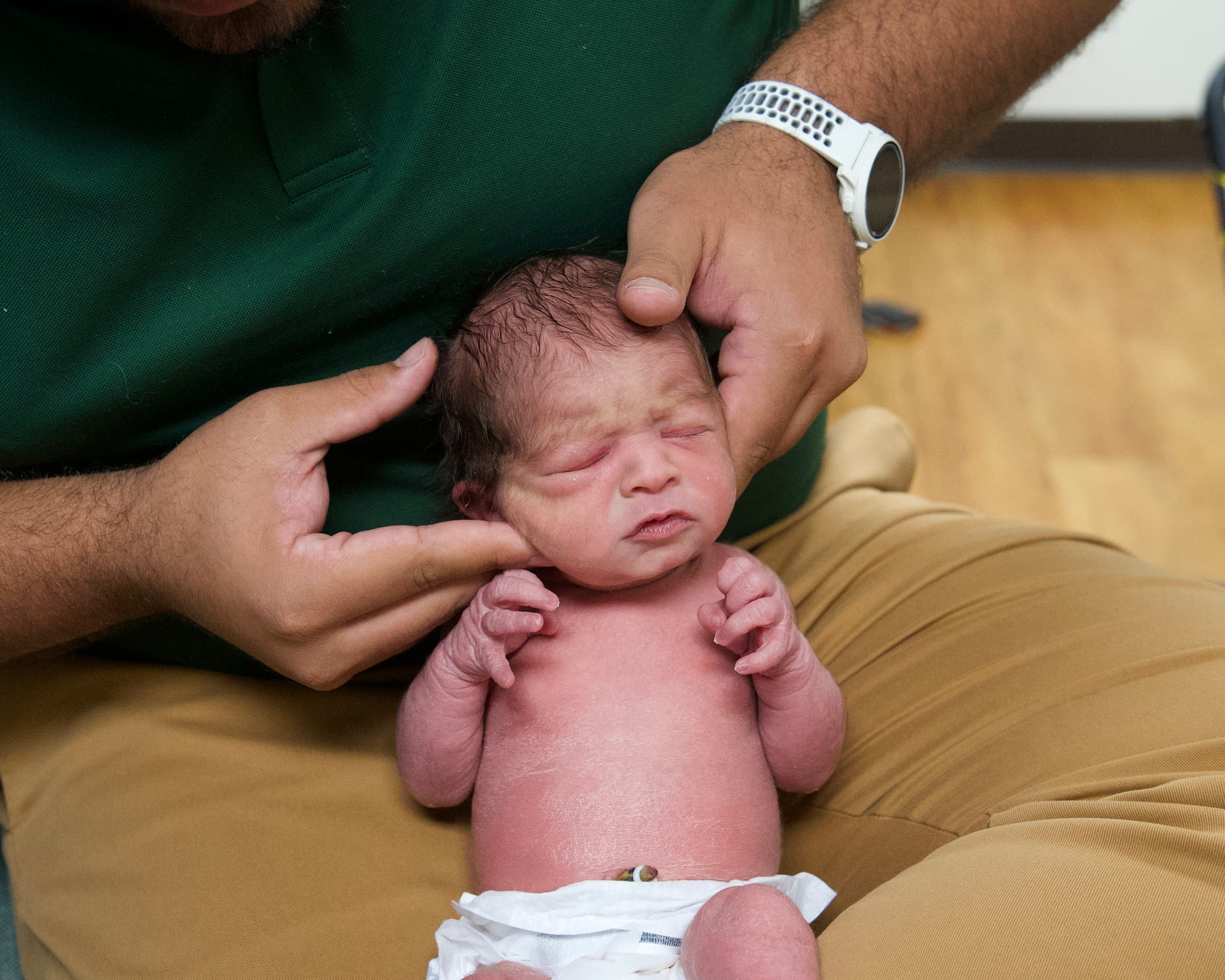 Dr. Vin gently adjusting a newborn at Sláinte Chiropractic