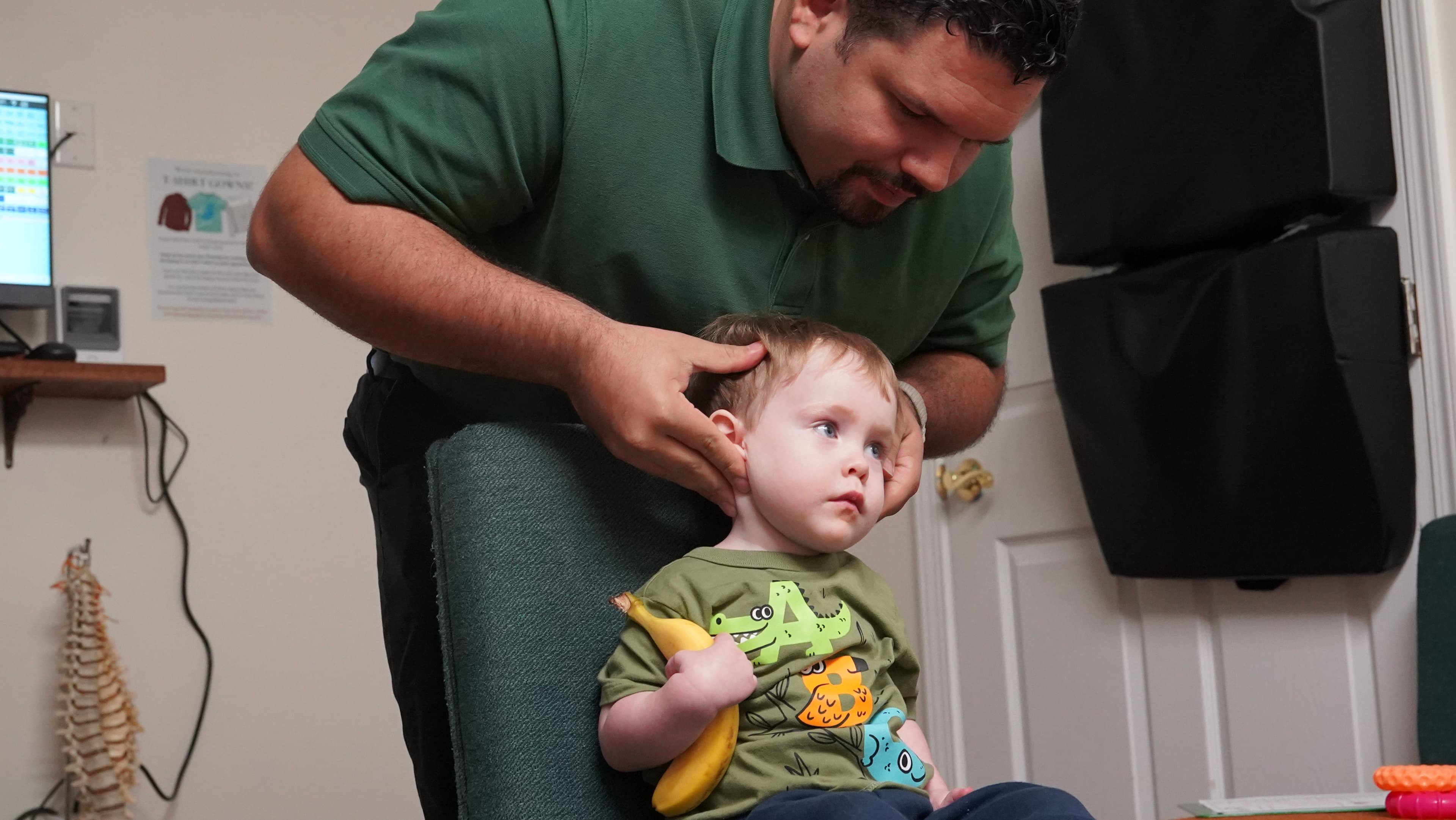 Dr. Vincent Farrar adjusting a toddler at Sláinte Chiropractic